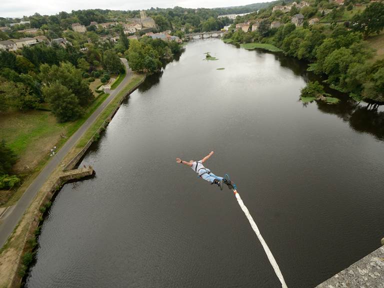Un individu accroché à une corde, surplombant la vienne, illustrant un moment de courage et d'exploration.